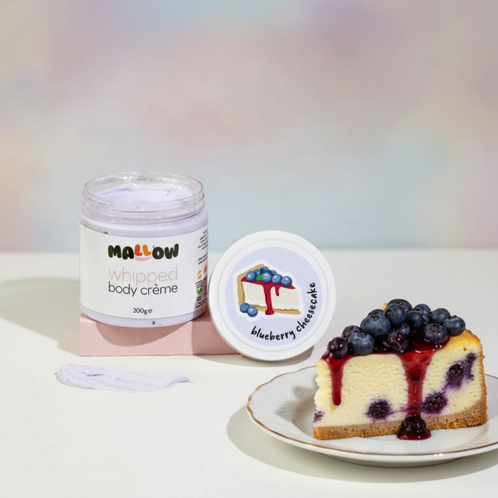 Jar of 'Mallow' whipped body crème and a slice of blueberry cheesecake on a light background