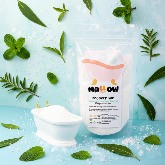 Bath salt packaging with peppermint, tea tree other leaves on a light blue background