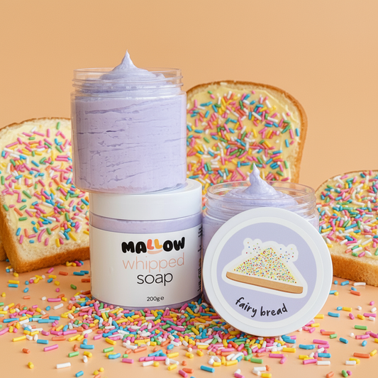 Mallow whipped soap with fairy bread design on a beige background with sprinkles.
