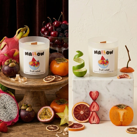 Two scented candles labeled MALLOW Fruit Salad are displayed in a split design. The left side, under the heading 'OPULENCE: A FESTIVAL OF EXOTIC FRUITS', shows the candle on a wooden table surrounded by dragon fruit, persimmon, oranges, and cherries.