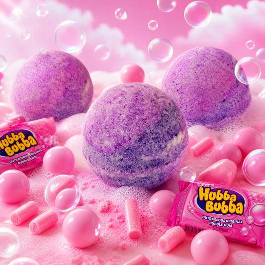Three purple bath bombs in a pink foamy setting with pink bubblegum candies and Hubba Bubba bubble gum packaging visible.